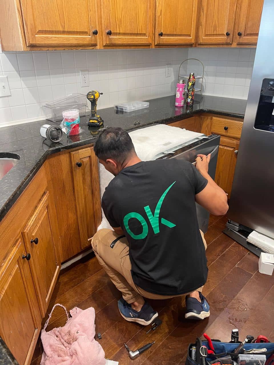 OK Appliance Repair technician servicing a dishwasher