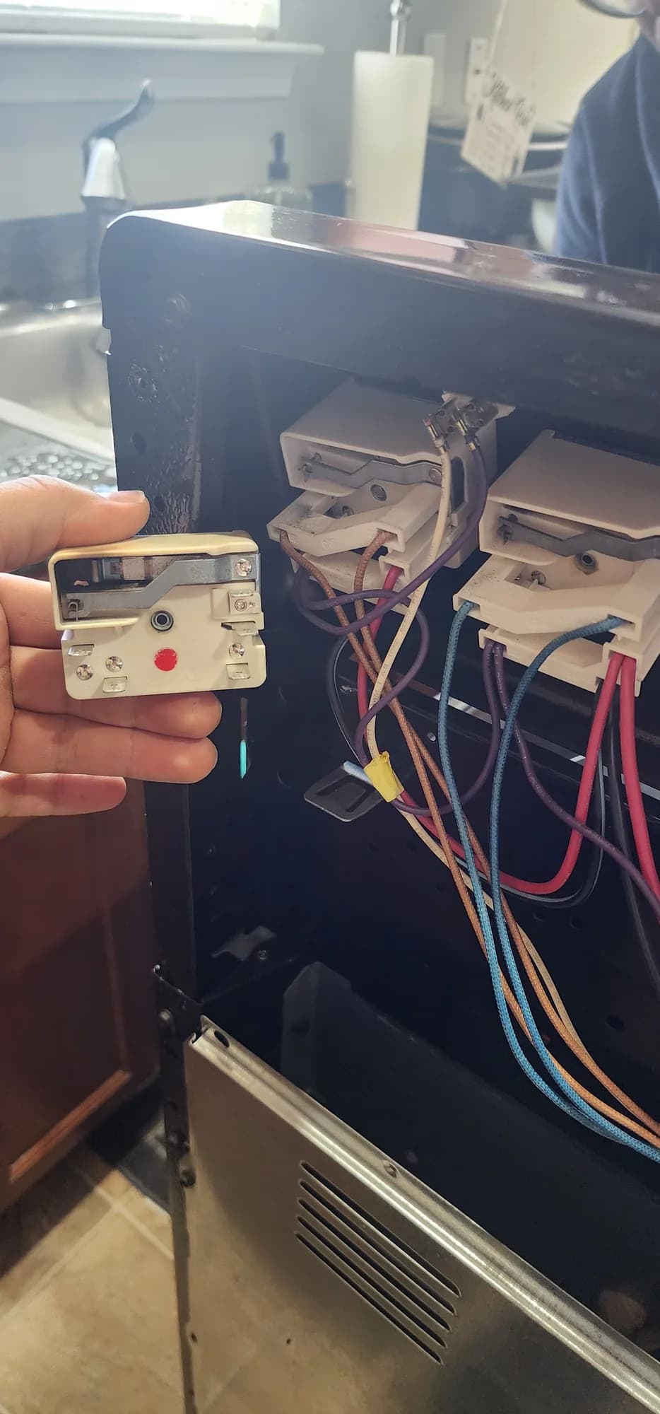 Burner control switch held near the control panel of the Frigidaire range